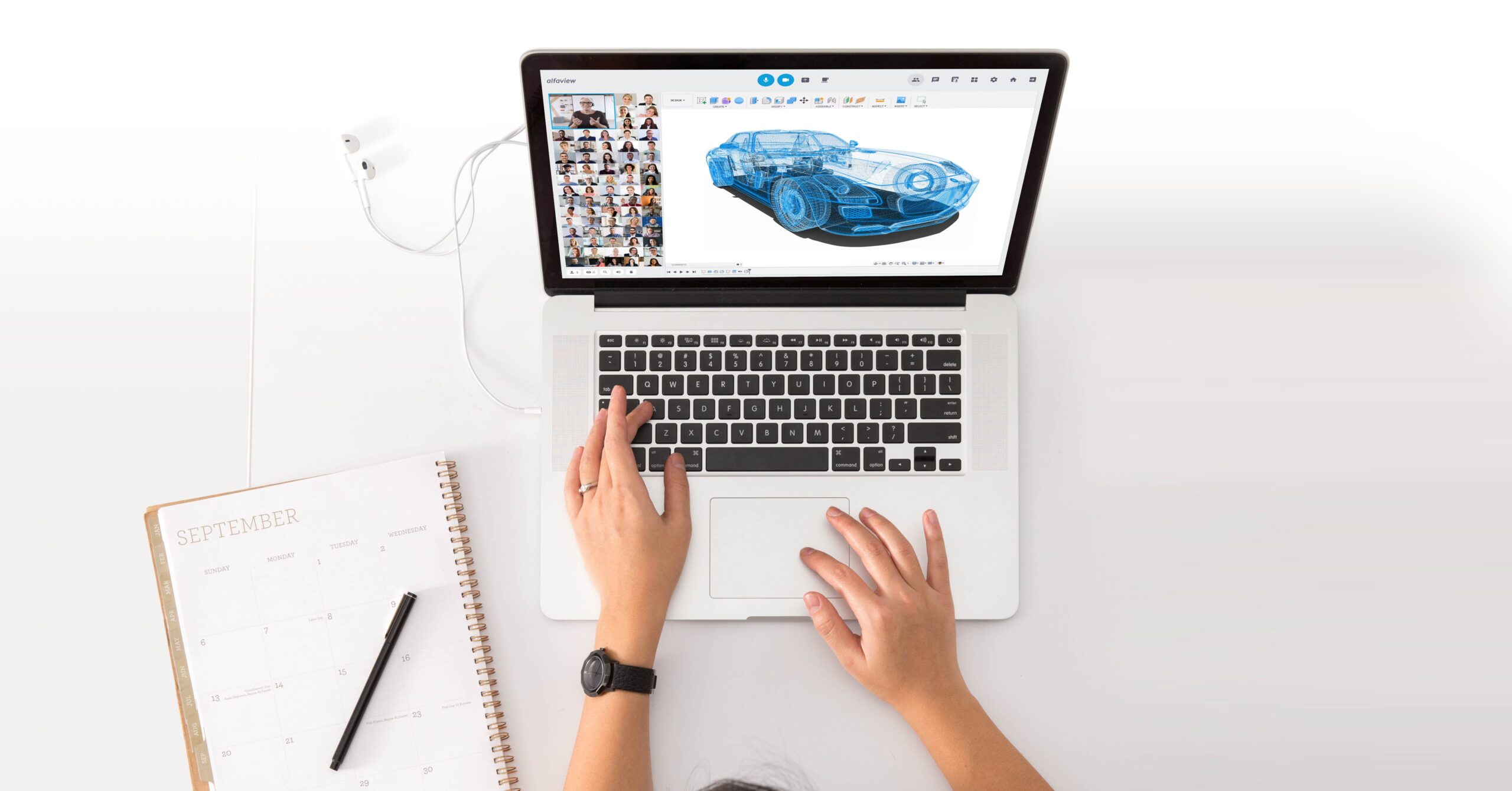 Laptop and notebook. On the laptop you can see a video conference with a CAD model of a car as the screen transmission